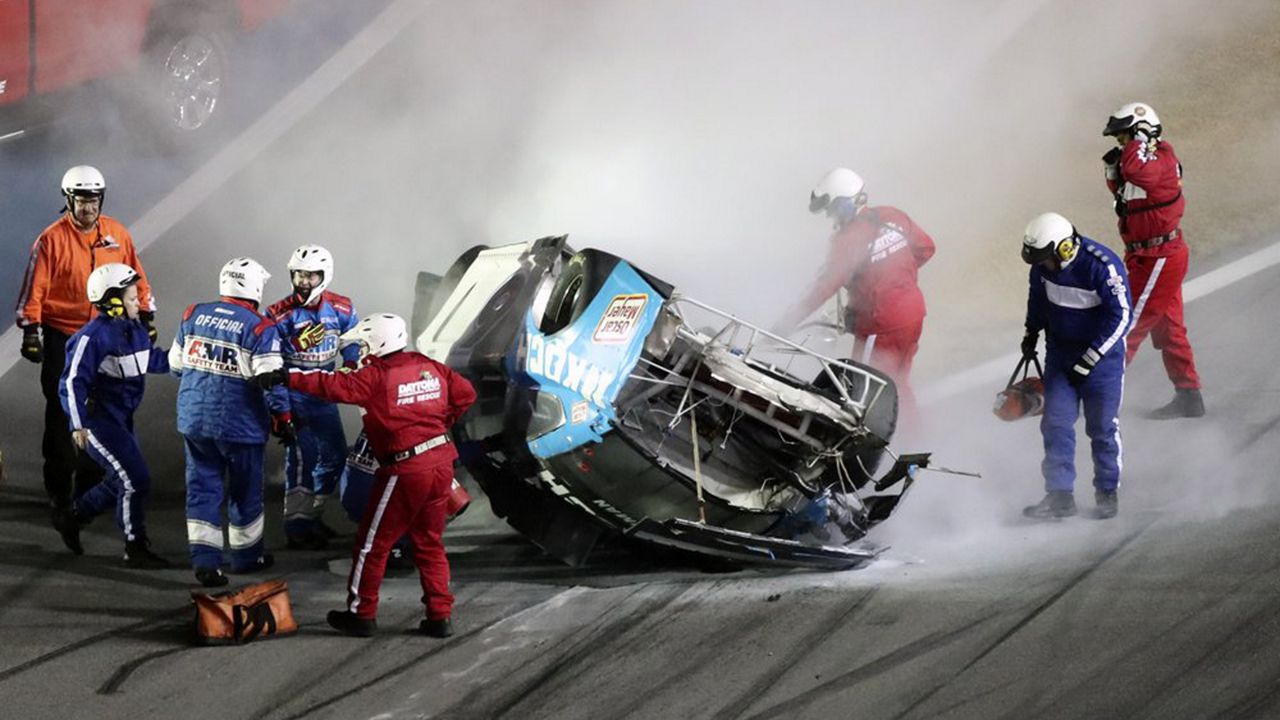 Rescue workers arrive to check on Ryan Newman after he was involved in a crash on the last lap of the Daytona 500 at Daytona International Speedway on Monday night. Sunday's race was postponed because of rain. (David Graham/AP)
