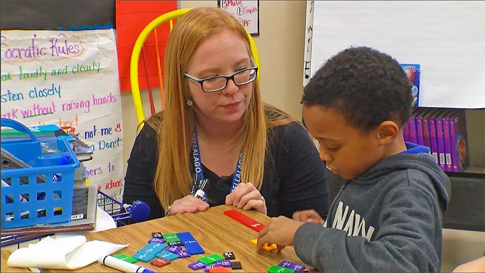 A teacher watches over a student. (Spectrum News File Image)