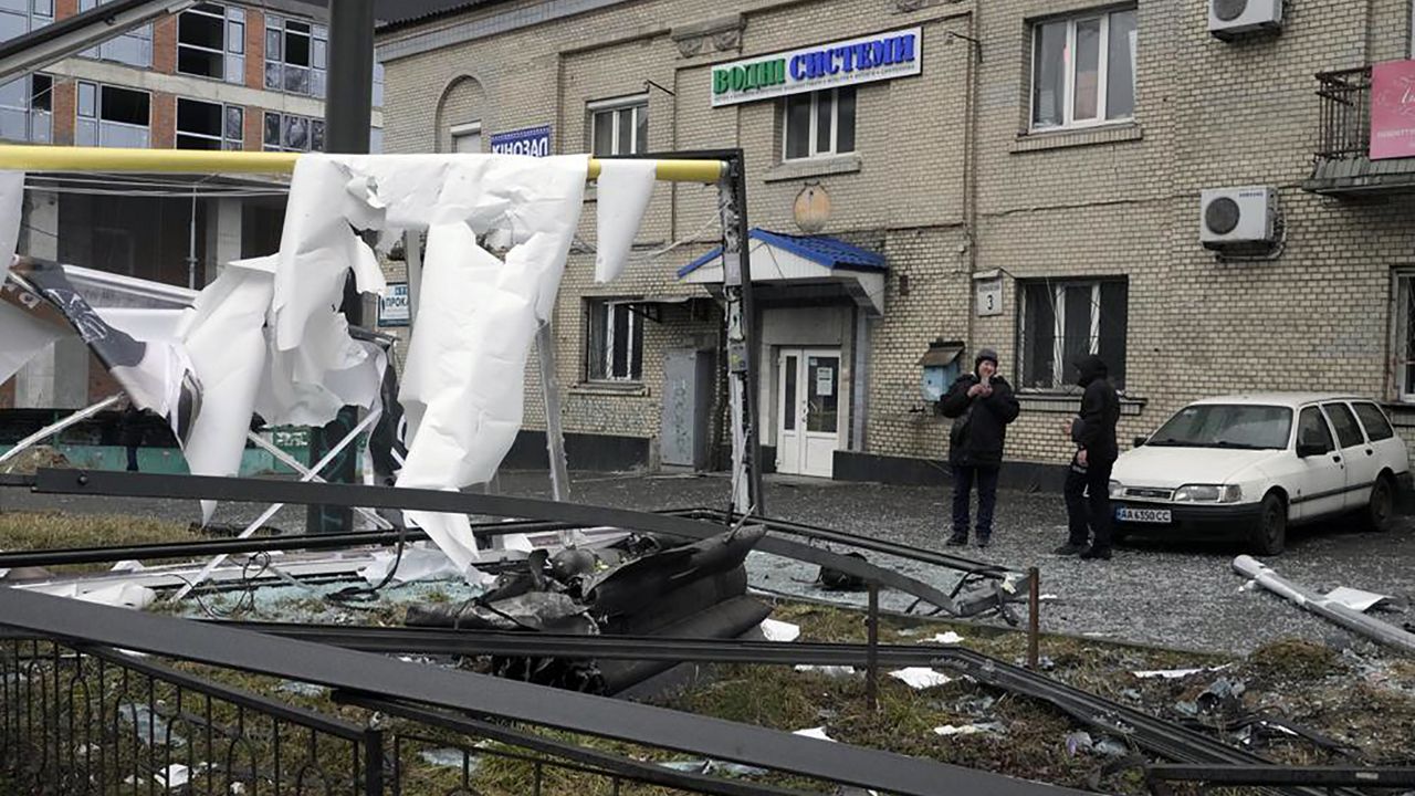 A woman takes a photo of the consequences of Russian shelling in Kyiv, Ukraine, Thursday, Feb. 24, 2022. Russian troops have launched their anticipated attack on Ukraine. Big explosions were heard before dawn in Kyiv, Kharkiv and Odesa as world leaders decried the start of an Russian invasion that could cause massive casualties and topple Ukraine's democratically elected government. (AP Photo/Efrem Lukatsky)