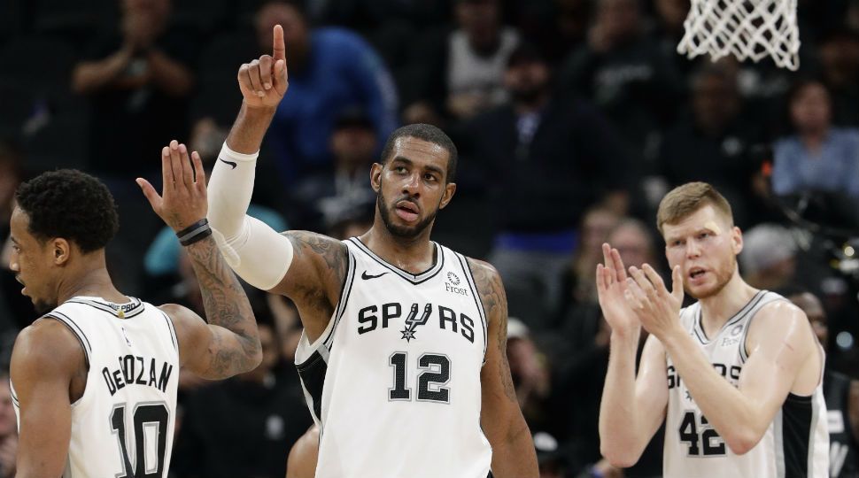 San Antonio Spurs center LaMarcus Aldridge (12) celebrates with teammates after he was fouled while scoring late in the the second half of an NBA basketball game against the Brooklyn Nets in San Antonio, January 31, 2019. San Antonio won 117-114. (AP Image)