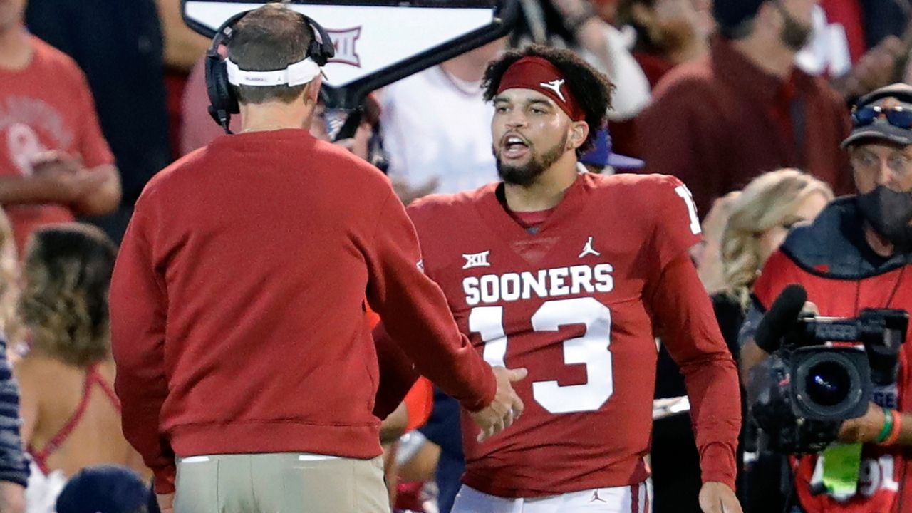 Oklahoma quarterback Caleb Williams (13) celebrates with head coach Lincoln Riley after a touchdown during the first half of an NCAA college football game against TCU, Saturday, Oct. 16, 2021, in Norman, Okla. (AP Photo/Alonzo Adams)