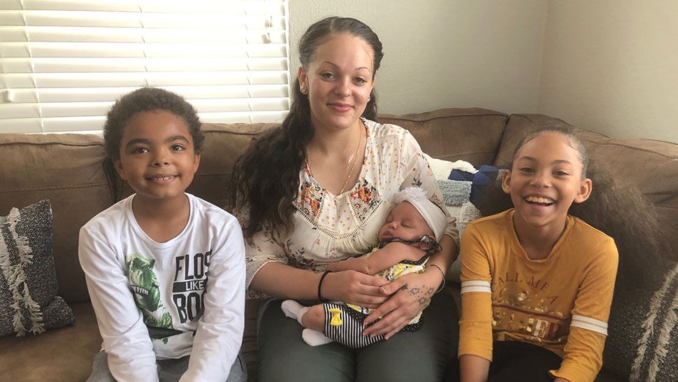 Jenna Dubose, center, and her children will soon be moving into a new home thanks to One More Child and Florida Baptist Children's Homes. (Stephanie Claytor/Spectrum Bay News 9)