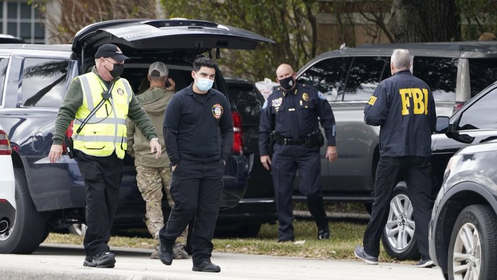 Law enforcement officers block an area where a shooting wounded several FBI agents while serving an arrest warrant, Tuesday, Feb. 2, 2021, in Sunrise, Fla. (AP Photo/Marta Lavandier)