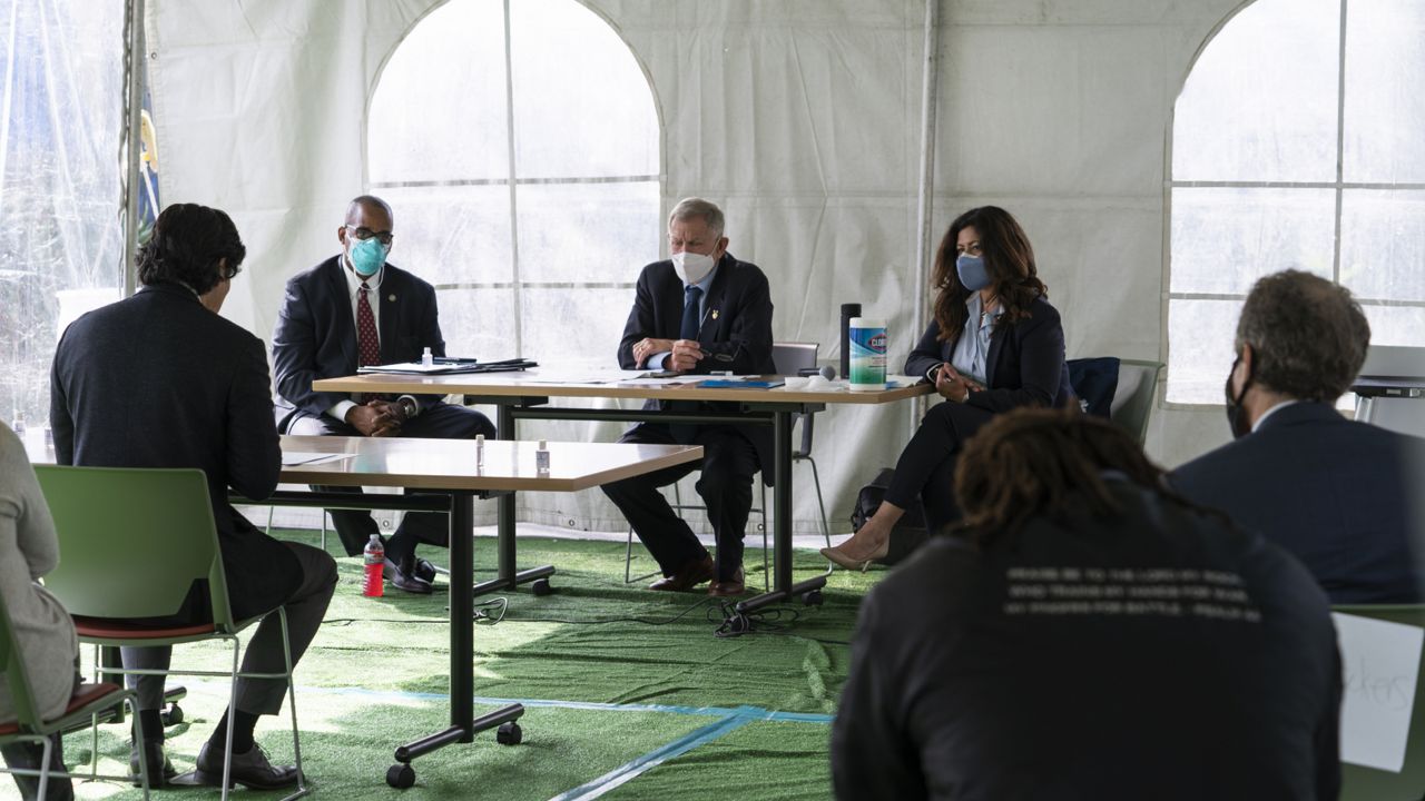 Los Angeles City Council member Kevin de Leon, far left, addresses U.S. District Judge Andre Birotte, second from left, U.S. District Court Judge David Carter, middle, and special master Michele Martinez, right, at a court hearing inside a tent at Downtown Women's Center in Los Angeles, Thursday, Feb. 4, 2021. (AP Photo/Damian Dovarganes)