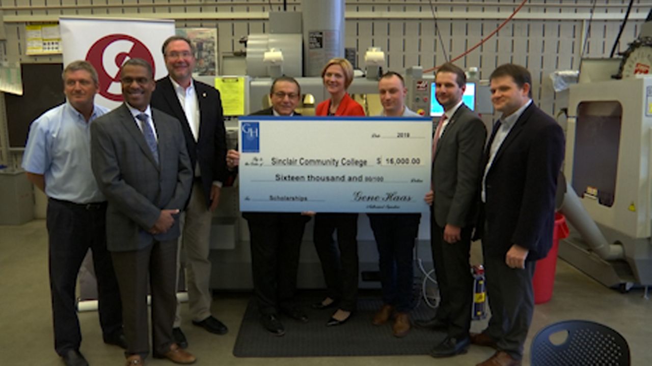 Group of people at Sinclair receiving a giant oversized check