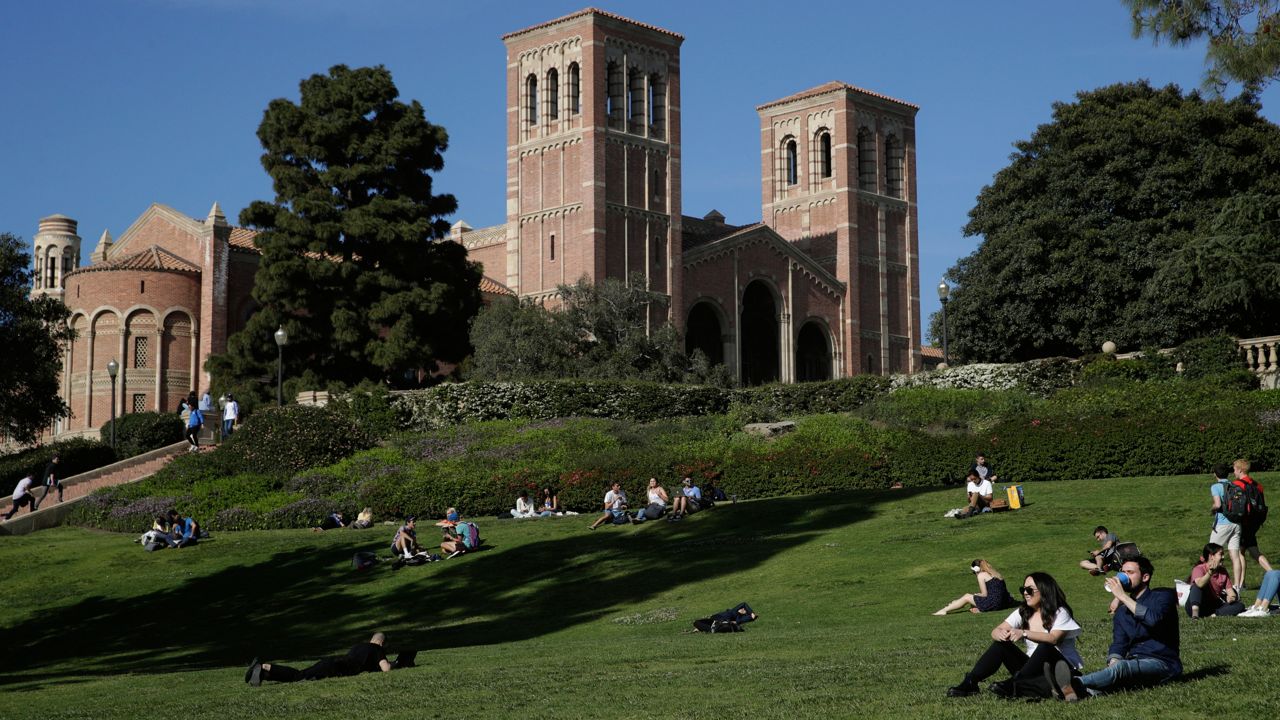 Students sit on the lawn near Royce Hall at UCLA in the Westwood section of Los Angeles on April 25, 2019. (AP Photo/Jae C. Hong, File)