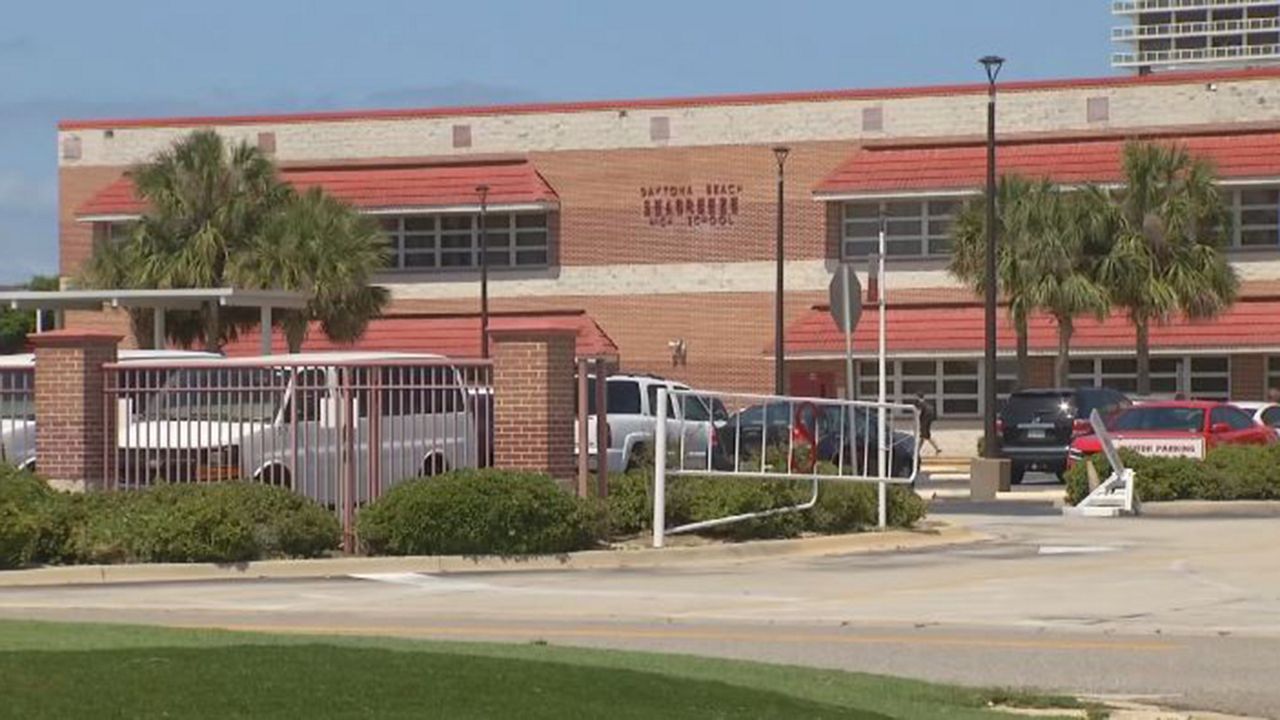 A TikTok video recorded at Seabreeze High School shows two students tripping another student. (Spectrum News 13)