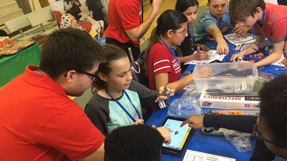 UCF students help  Piedmont Lakes Middle Schoolers during the a STEM event Friday to spark the teens' interest in science and technology careers. (Julie Gargotta, Spectrum News)