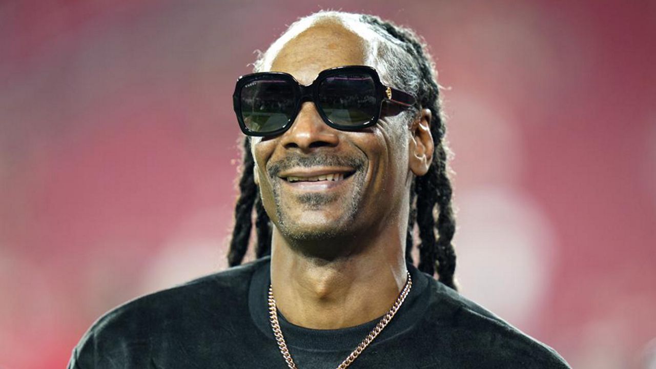 Entertainer Snoop Dogg walks on the field before an NFL football game between the Tampa Bay Buccaneers and the New Orleans Saints Sunday, Dec. 19, 2021, in Tampa, Fla. (AP Photo/Chris O'Meara, File)