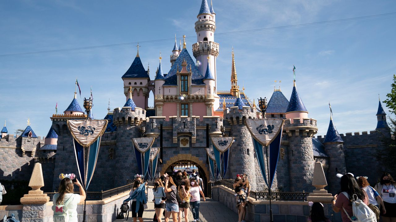 Visitors pass through Disneyland in Anaheim, Calif., on April 30, 2021. (AP Photo/Jae C. Hong)