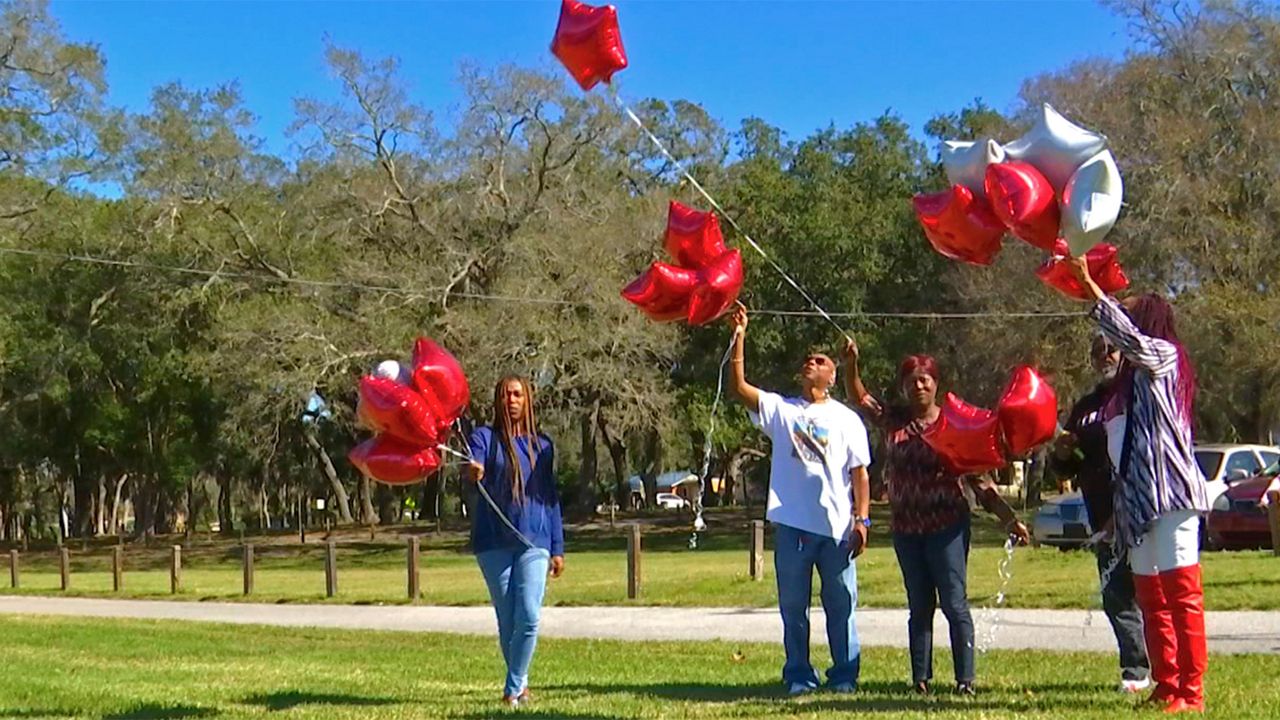 Family and friends released balloons in honor of Clarence Bolden, who was gunned down in 2002. But they say they are far from closure. (Gabrielle Arzola/Spectrum Bay News 9)