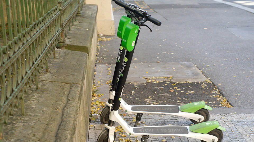 Lime scooters line the sidewalk. (Spectrum News file image)