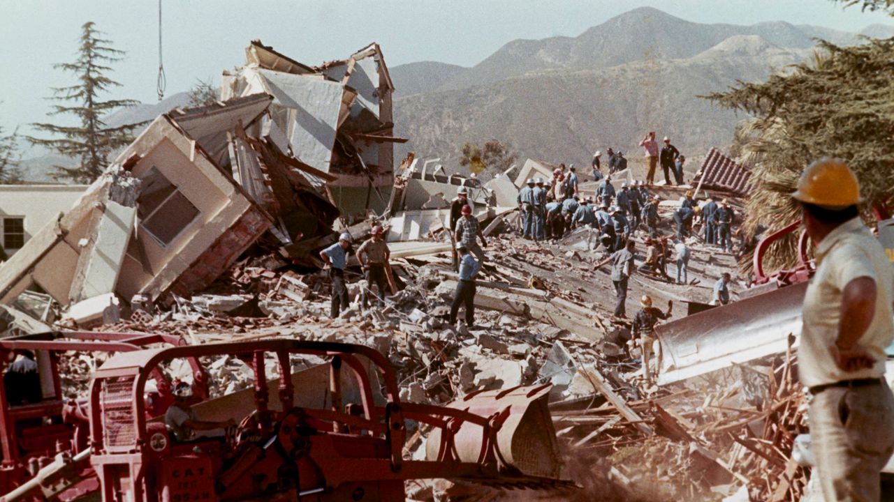 Workers clear debris and rubble from collapsed buildings at the Veteran's Hospital in the Los Angeles neighborhood of Sylmar, Calif., after a massive earthquake hit the area on Feb. 9, 1971. (AP Photo)
