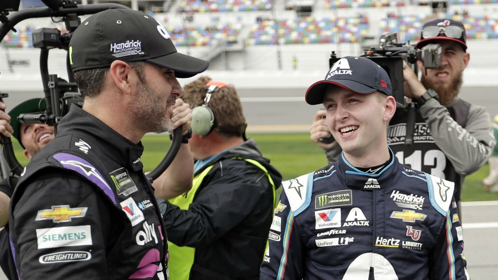 William Byron, right, is congratulated by Jimmie Johnson, left, after winning the pole position during qualifying for the Daytona 500 auto race at Daytona International Speedway, Sunday, Feb. 10, 2019, in Daytona Beach, Fla. (AP Photo/John Raoux)