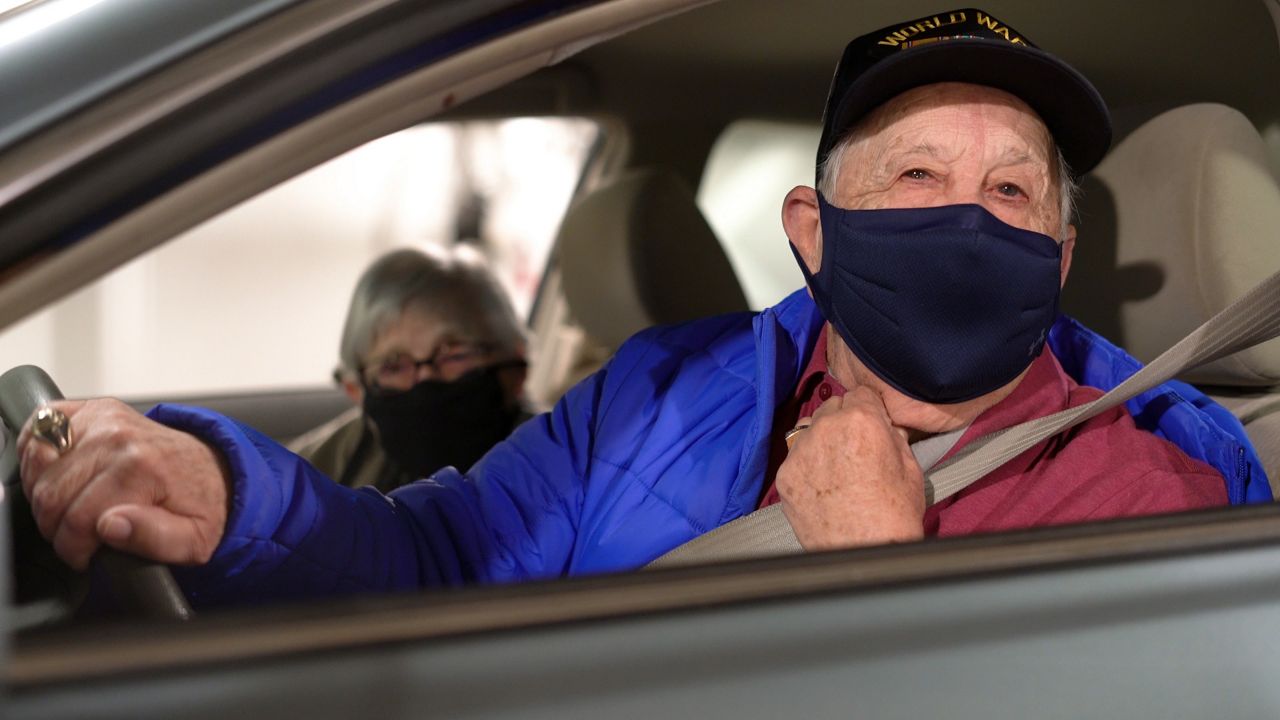 An elderly man and woman in a car