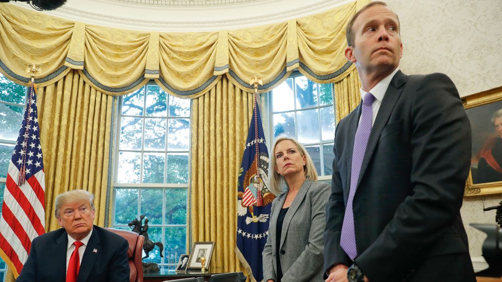 FEMA director Brock Long, right, stands in the Oval Office in a meeting with Homeland Security Secretary Kirstjen Nielsen and President Trump for a meeting about Hurricane Michael. (File/AP)