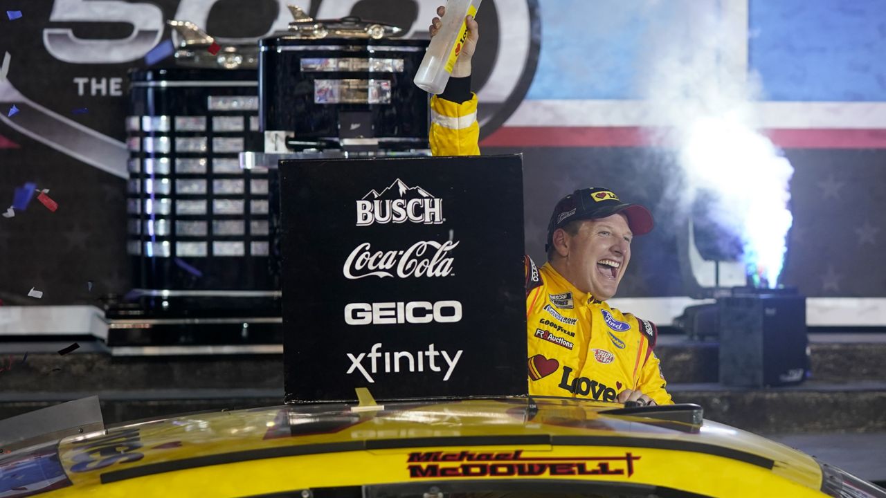 Michael McDowell celebrates after winning the NASCAR Daytona 500 auto race at Daytona International Speedway, Monday, Feb. 15, 2021, in Daytona Beach, Fla. (AP Photo/John Raoux)