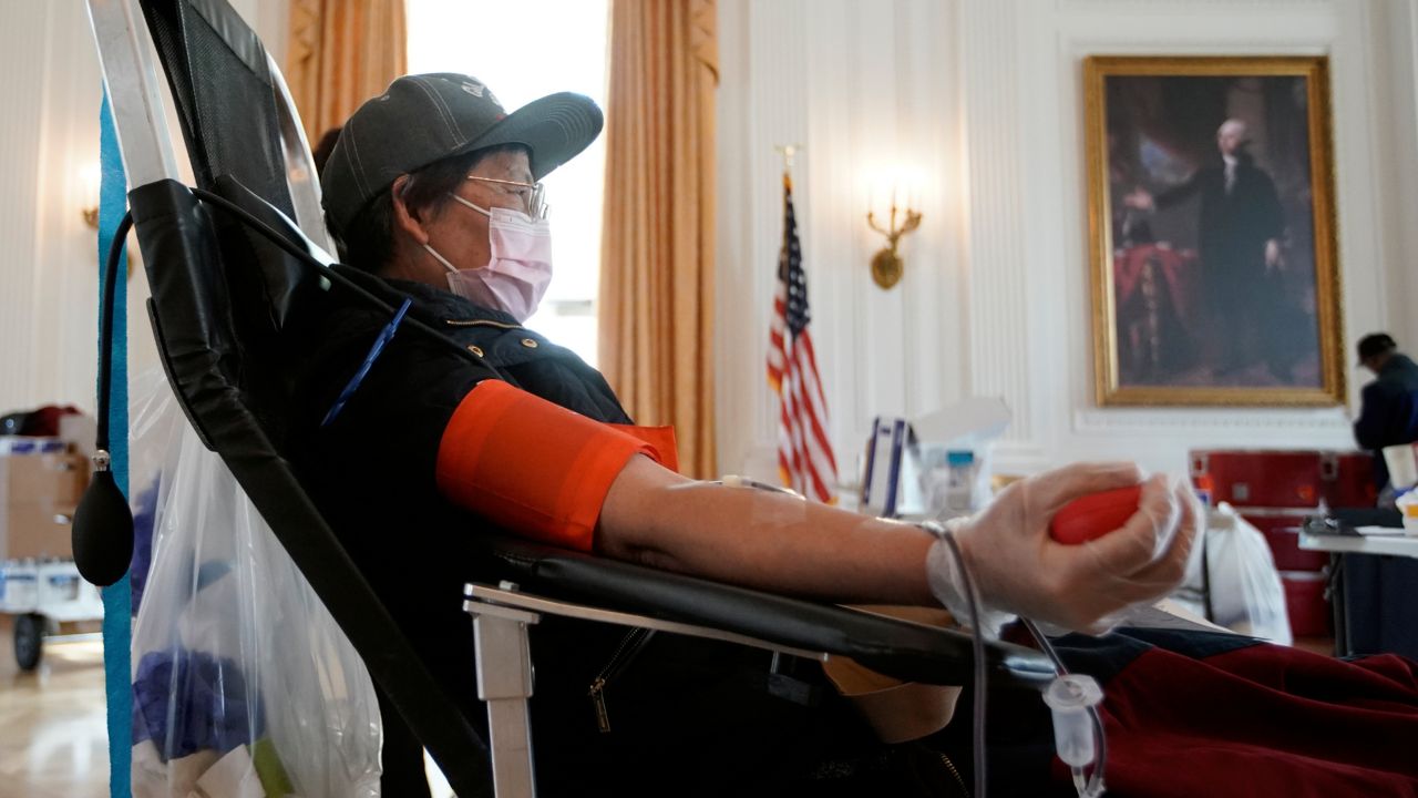 Sugin Quang donates at a blood drive hosted by the Richard Nixon Presidential Library to help meet the urgent demand for donations amid the coronavirus outbreak across the United States in Yorba Linda, Calif., Tuesday, March 31, 2020. (AP Photo/Chris Carlson)