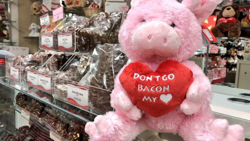 A pink rabbit sits in front of a pile of chocolate. (Spectrum News images)