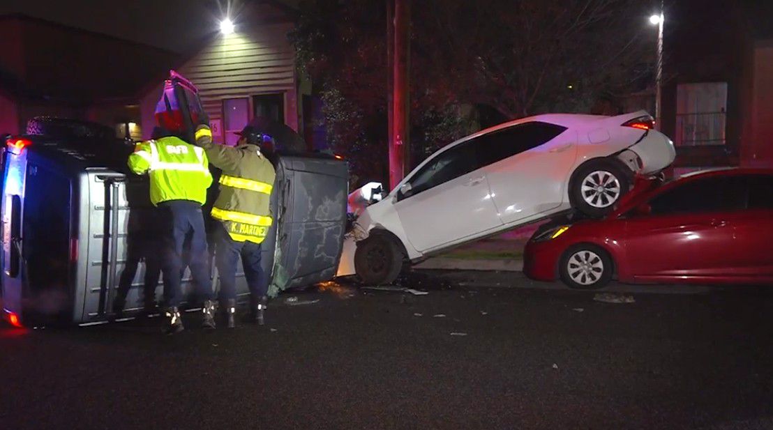 First responders attempt to move a flipped car part of a three-car crash. (Courtesy: Metro Video Services)