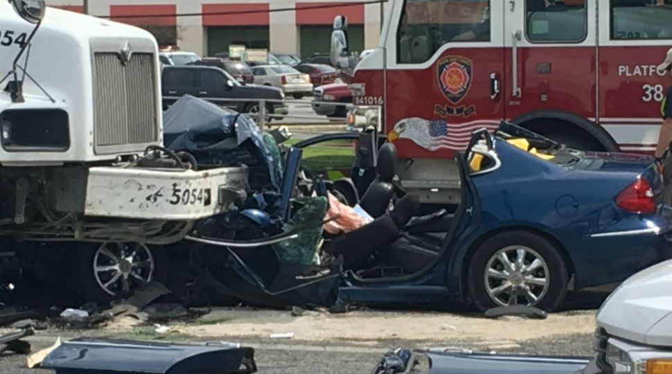 Car underneath cement truck after crash February 14, 2019 (Spectrum News)