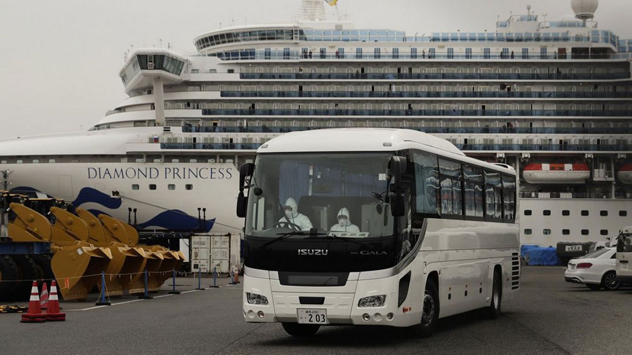 A bus leaves a port where the quarantined Diamond Princess cruise ship is docked Saturday, Feb. 15, 2020, in Yokohama, near Tokyo.  (AP Photo/Jae C. Hong)