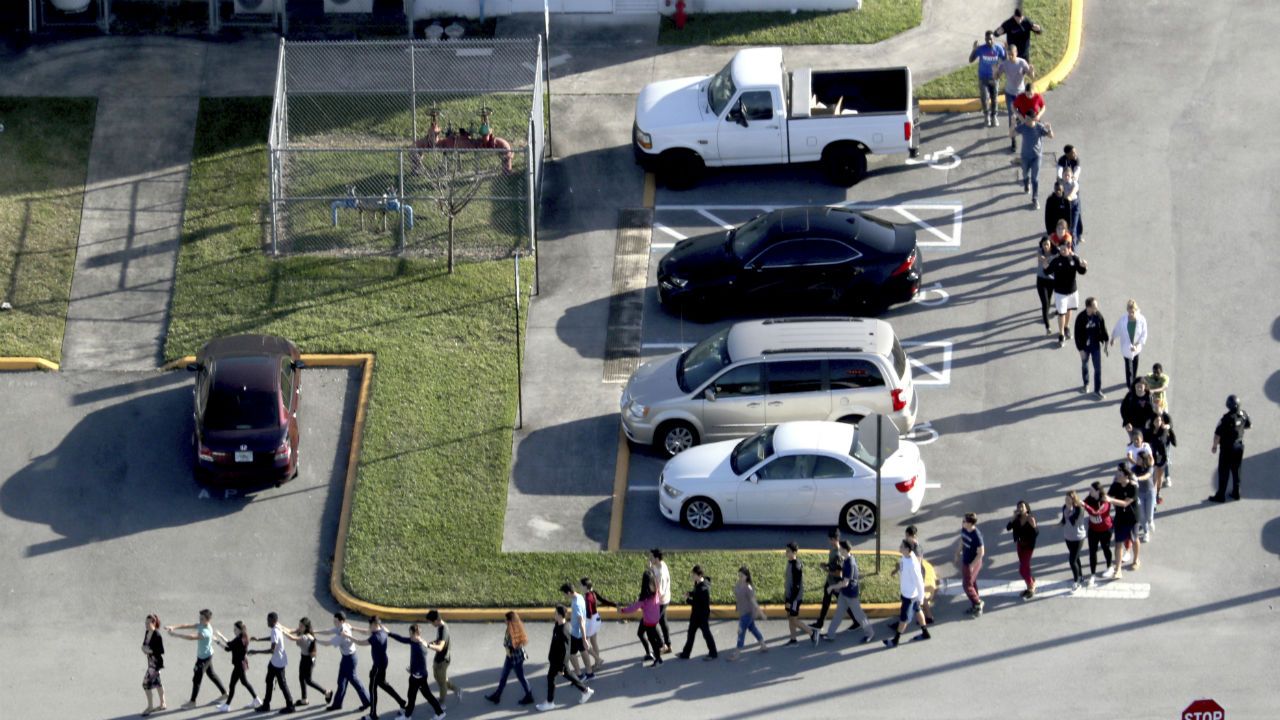 Students leave  Marjory Stoneman Douglas High during Valentine's Day shooting. 