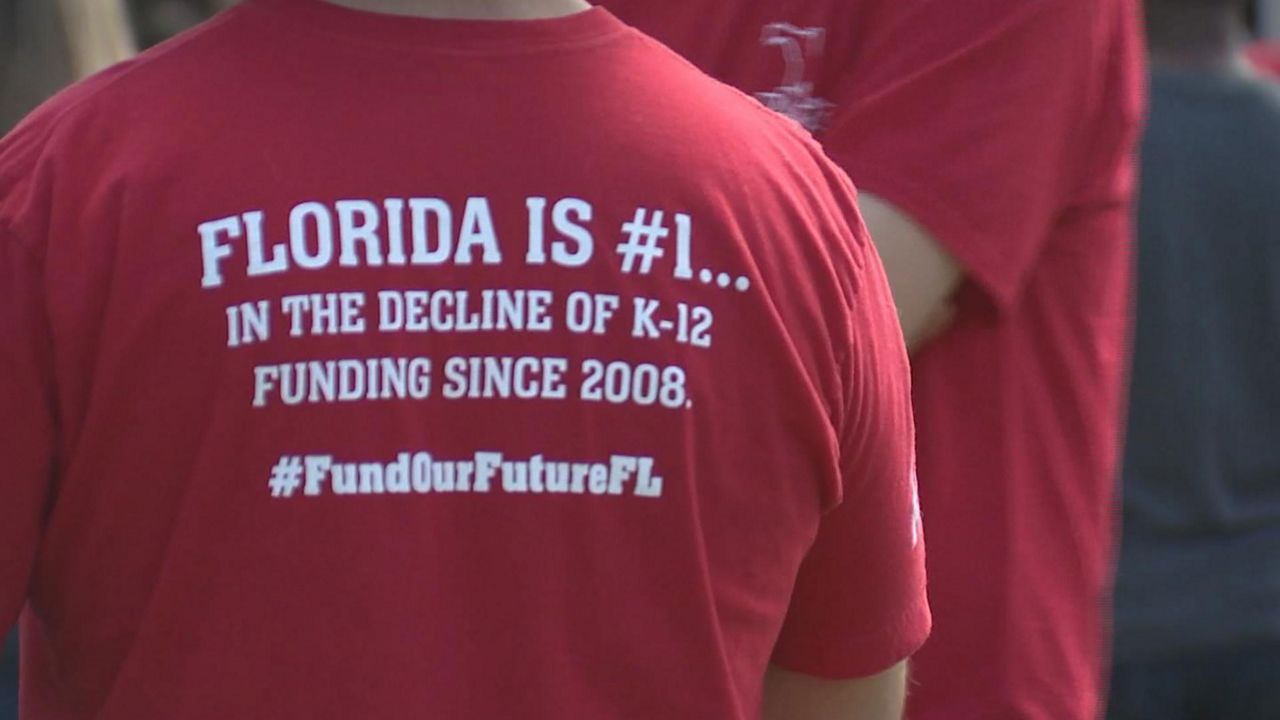 Hundreds of teachers rallied for better school funding and teacher pay at Lake Eola in Orlando Saturday. (Spectrum News)