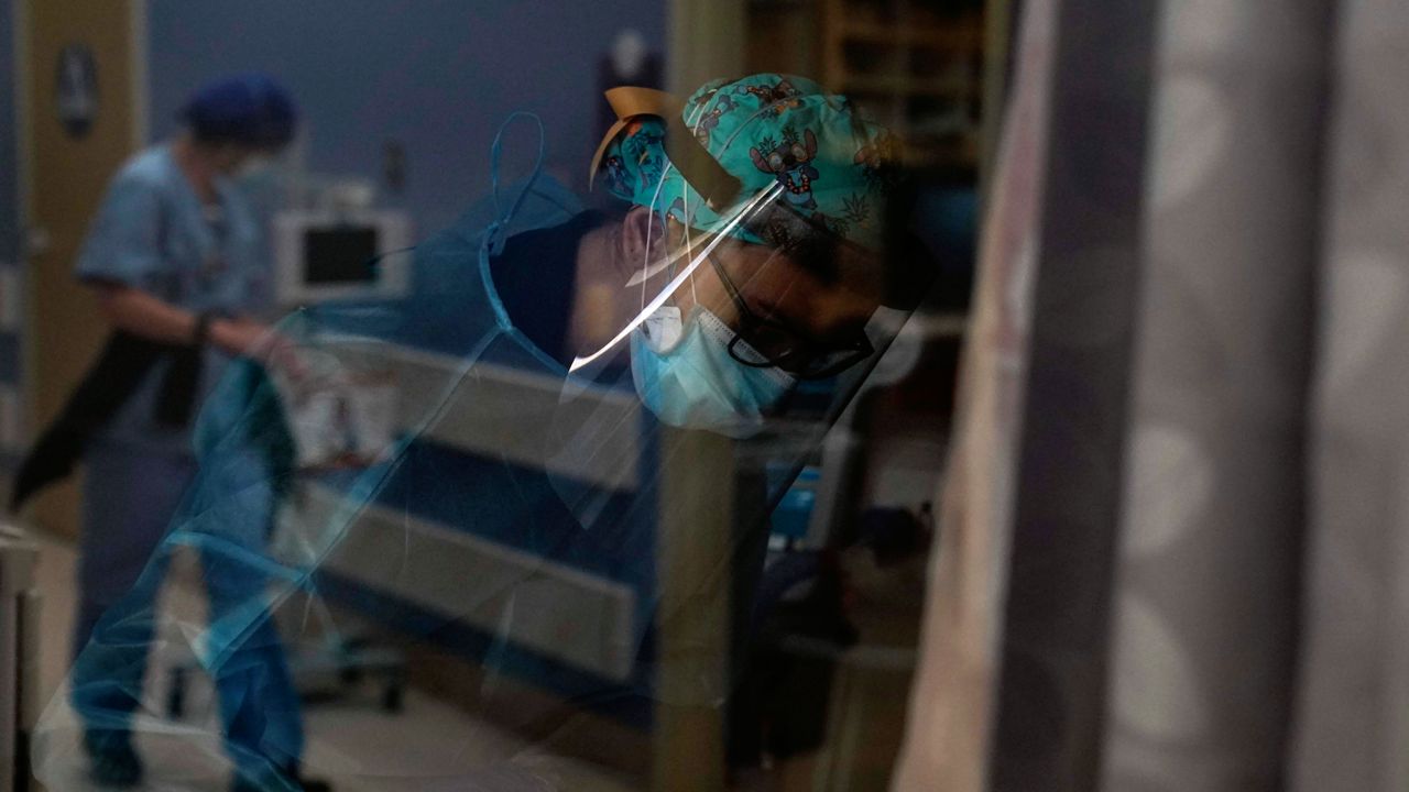 Registered nurse Kyanna Barboza tends to her COVID-19 patient at St. Joseph Hospital in Orange, Calif., Thursday, Jan. 7, 2021. (AP Photo/Jae C. Hong)