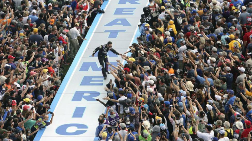 Jimmie Johnson greets fans during driver introductions before the NASCAR Daytona 500 auto race at Daytona International Speedway, Sunday, Feb. 16, 2020, in Daytona Beach, Fla. (AP Photo/David Graham)