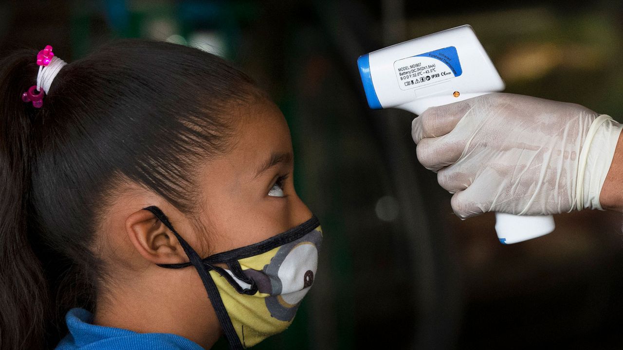 Child receiving a temperature check