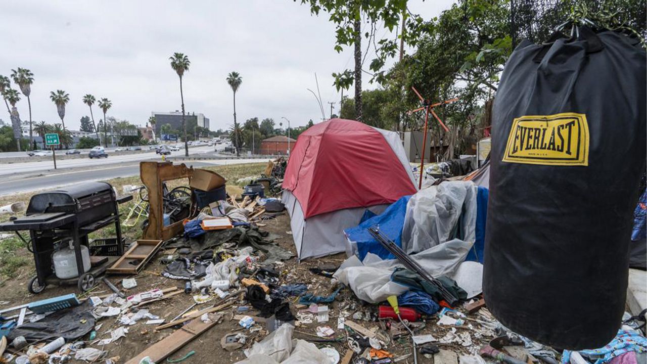 A trashed punching bag is left at a homeless encampment on the side of the CA-101 highway in Echo Park neighborhood in Los Angeles Tuesday, May 11, 2021. (AP Photo/Damian Dovarganes,File)