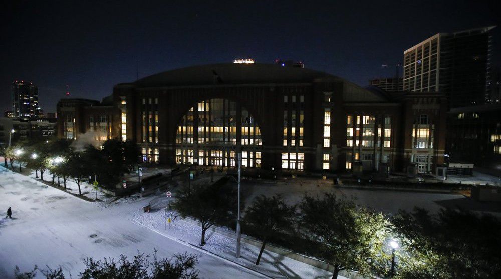 In order to save electricity, the promenade lights and screens are turned off in front of American Airlines Center which was to host the Nashville Predators and the Dallas Stars NHL hockey game, Monday, Feb. 15, 2021, in Dallas. (AP Photo/Brandon Wade)
