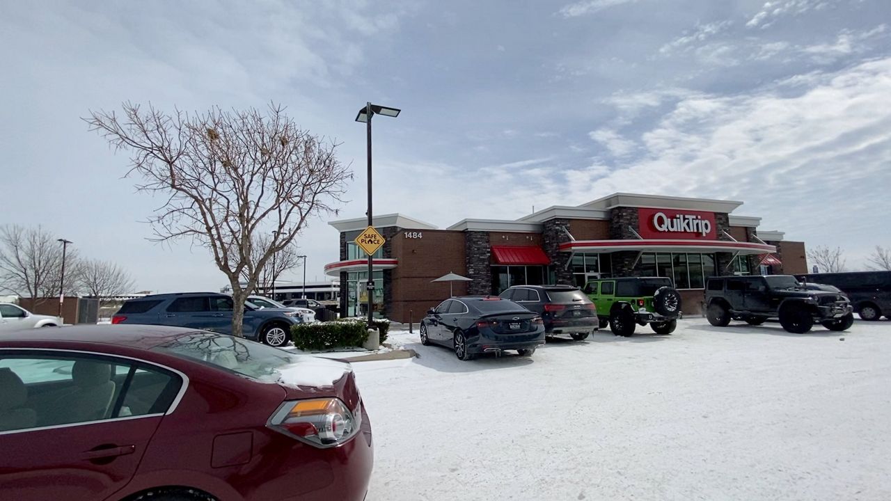 A busy parking lot of parked cars at a QuickTrip convenient store in Coppell, TX.