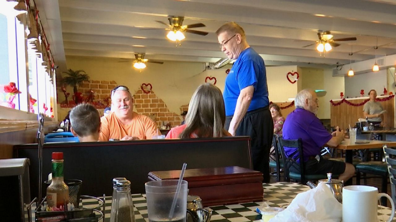 Good Thymes Restaurant owner Jeffrey Chamberlain (center, standing up) likes greeting his customers and getting to know their stories. (Krystel Knowles/Spectrum News 13)
