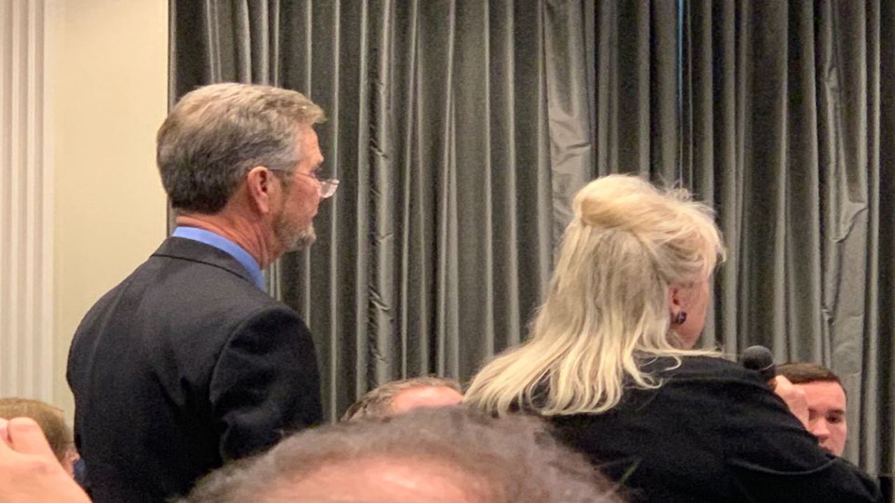 McCrae Dowless standing with his attorney