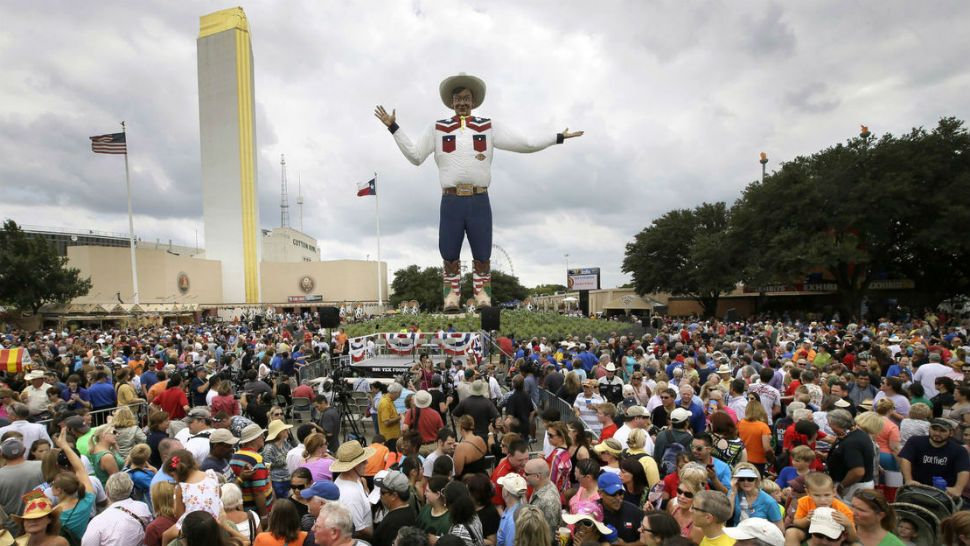 FILE- This Sept. 27, 2013, file photo shows thousands of visitors to the Texas State Fair making their way around the fairgrounds circle after an official ceremony where the 55-foot-tall Big Tex fair symbol welcomed everyone to the fair, in Dallas. The theme of the 2018 State Fair will be "Celebrating Texas Innovation." Officials with the State Fair of Texas on Monday, Feb. 19, 2018, announced the theme for the event scheduled Sept. 28 through Oct. 21 at Fair Park in Dallas. (AP Photo/Tony Gutierrez, File)