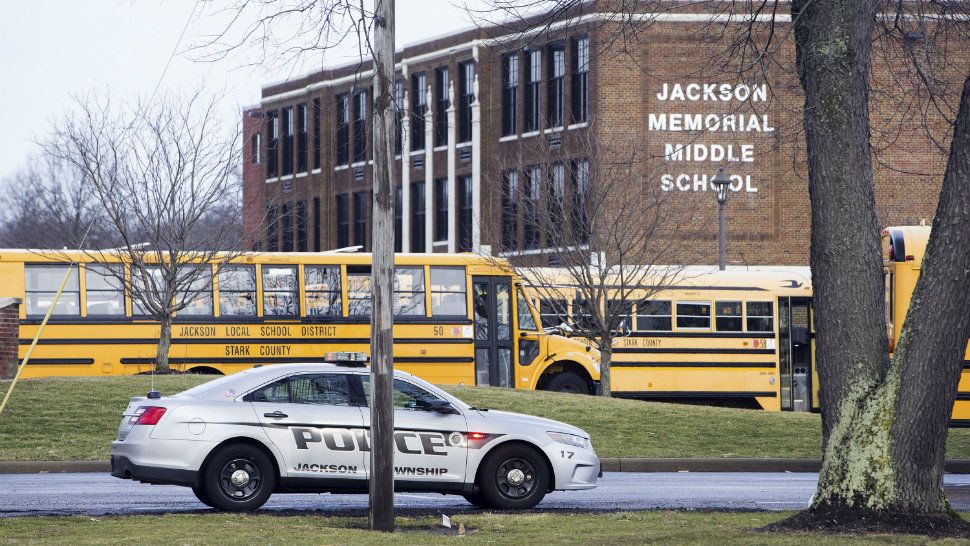 A police car is parked outside Jackson Township Middle School, Tuesday, Feb. 20, 2018 in Massillon, Ohio. A school official in Ohio says a middle school student apparently shot himself after bringing a gun to school. Police say Jackson Middle School, near Massillon, is on lockdown Tuesday and that the students and staff are safe.(Bob Rossiter/The Canton Repository via AP)
