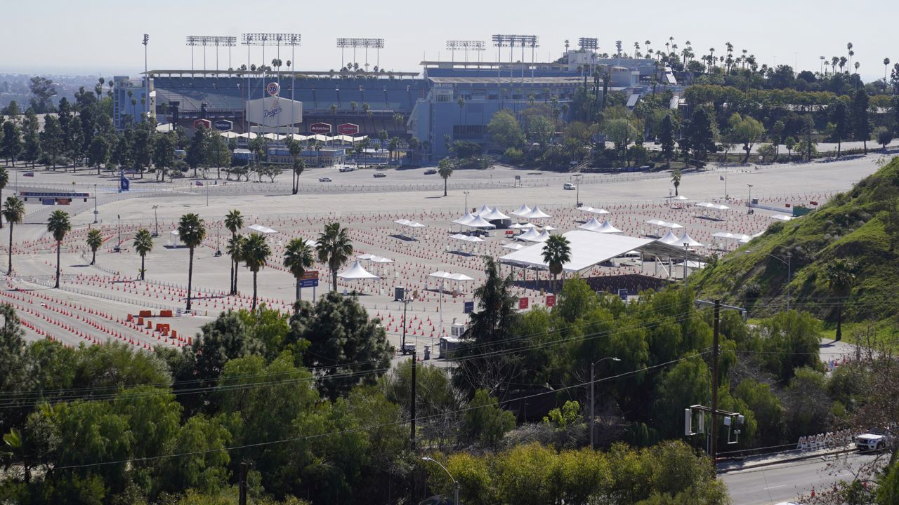 The parking lot of Dodger Stadium, a mass COVID-19 vaccination site is seen empty of activity in Los Angeles Friday, Feb. 19, 2021. (AP Photo/Damian Dovarganes)