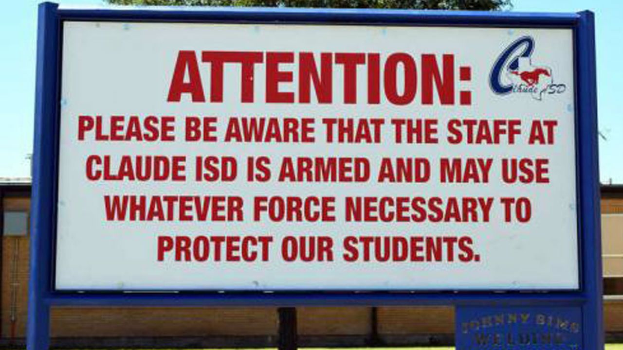 A sign posted outside a Texas school warning of armed staff members.
