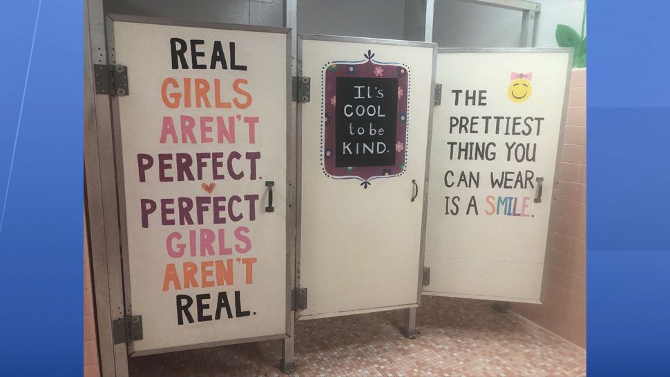 A small group of students at Carlton Palmore Elementary in Lakeland have painted motivational messages on bathroom stalls. (Stephanie Claytor/Spectrum News)