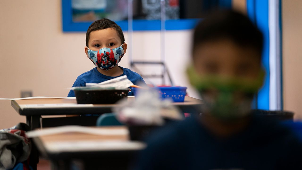 Nathan Ramos sits in a kindergarten classroom on the first day of in-person learning at Maurice Sendak Elementary School in Los Angeles, Tuesday, April 13, 2021. (AP Photo/Jae C. Hong)