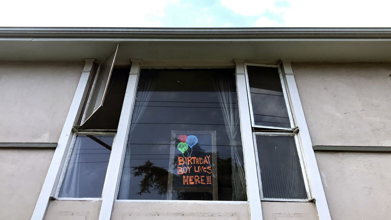 A sign in an apartment window announces a birthday as stay-at-home orders continue in California due to the coronavirus, Saturday, April 4, 2020, in Los Angeles. (AP Photo/Chris Pizzello)