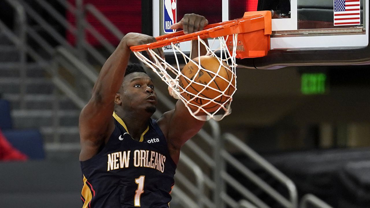 New Orleans Pelicans forward Zion Williamson (1) slam dunks the ball against the Toronto Raptors during the first half of an NBA basketball game Wednesday, Dec. 23, 2020, in Tampa, Fla. (AP Photo/Chris O'Meara)