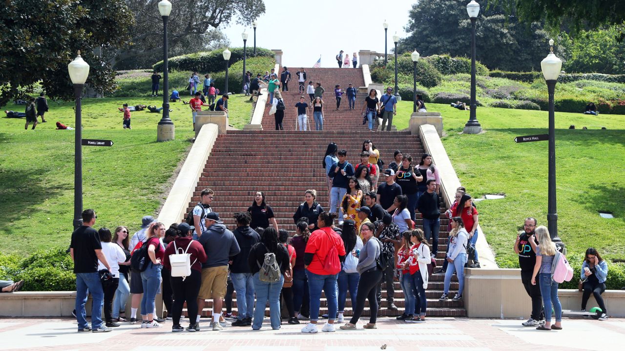 People move about the campus of the University of California, Los Angeles Friday, April 26, 2019. (AP Photo/Reed Saxon)