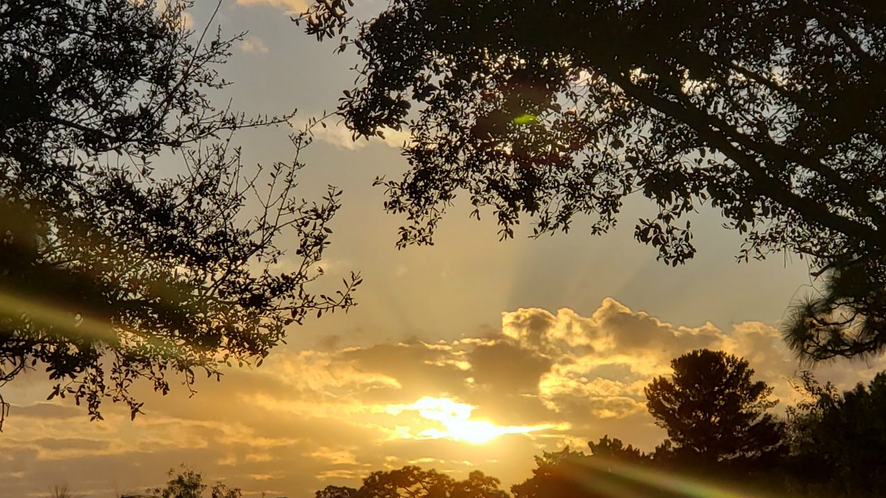 The orange sun breaks through the clouds Sunday morning in Brooksville ahead of a warm day. (Madeline/viewer)