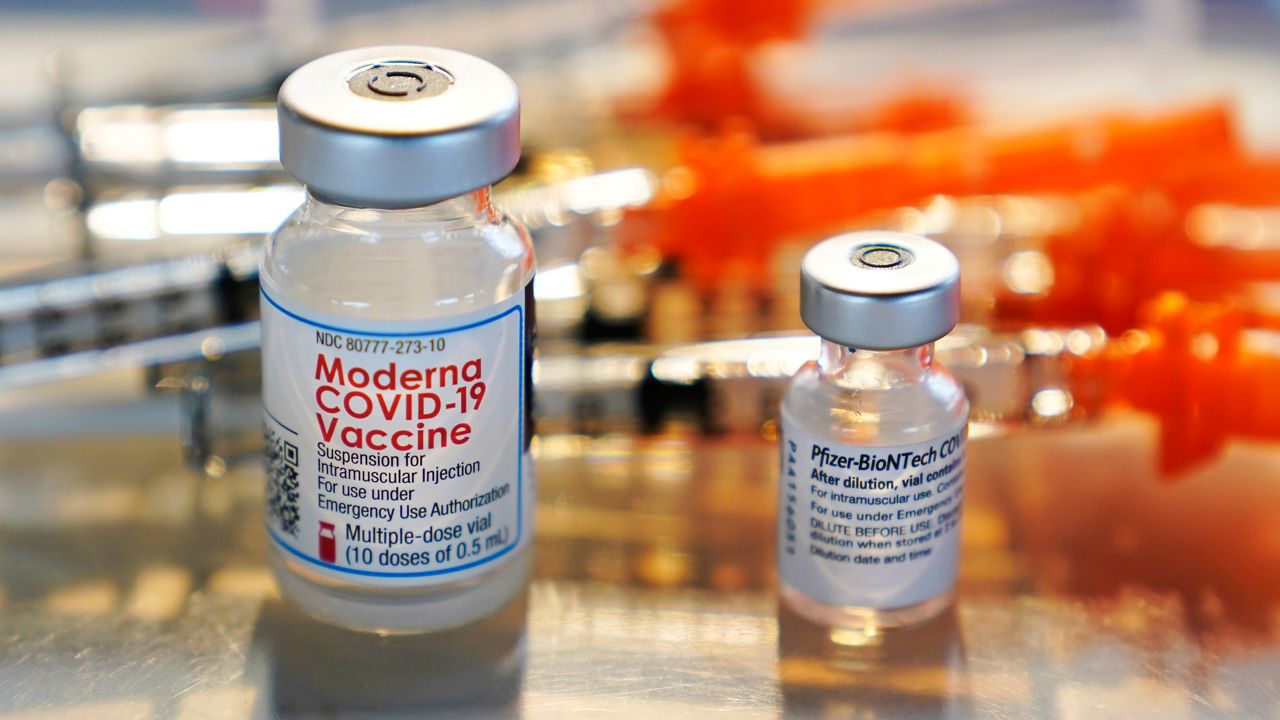 A February 25, 2021, photo of vials of the Moderna and Pfizer COVID-19 vaccines.