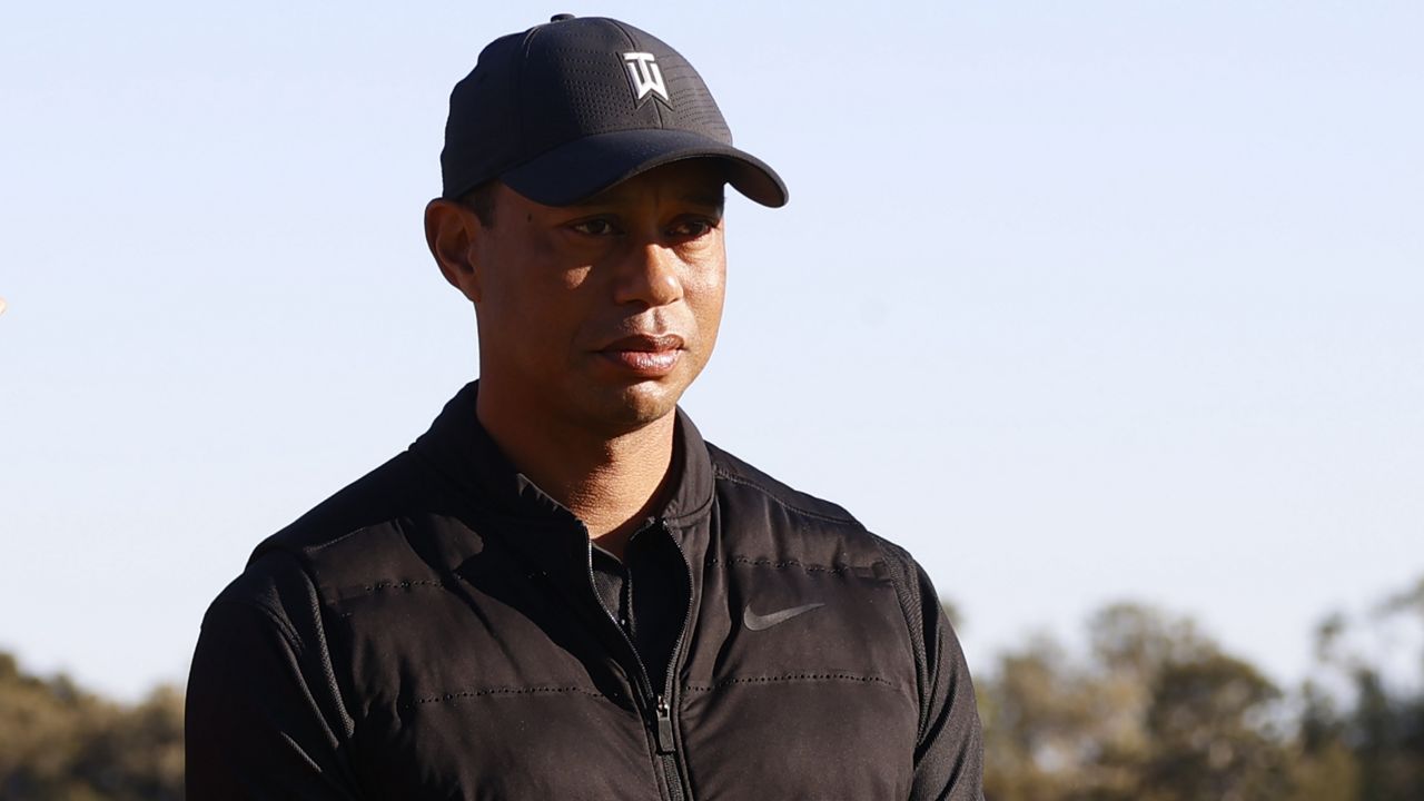 Tiger Woods looks on during the trophy ceremony on the practice green after the final round of the Genesis Invitational golf tournament at Riviera Country Club, Sunday, Feb. 21, 2021, in the Pacific Palisades area of Los Angeles. (AP Photo/Ryan Kang)