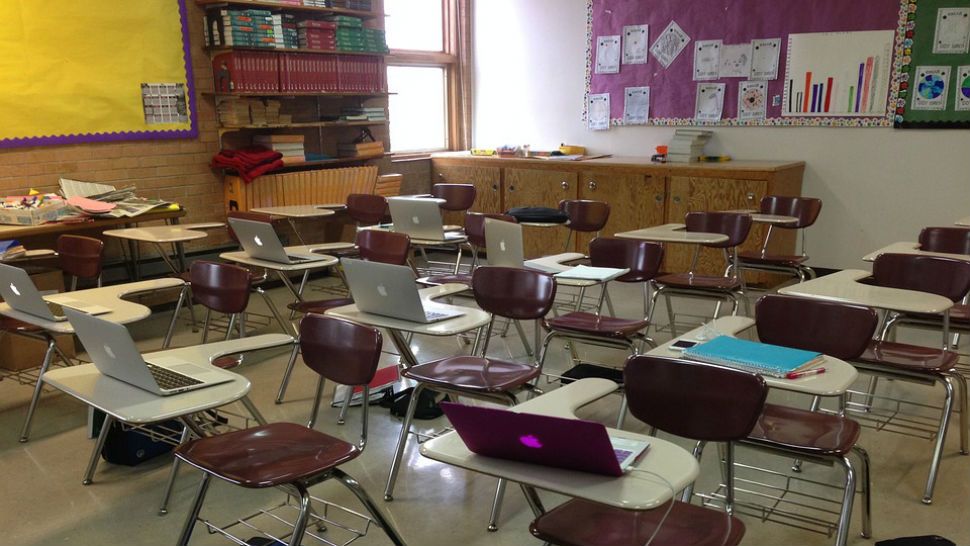 A row of empty desks in a classroom. (Spectrum News File Photograph)