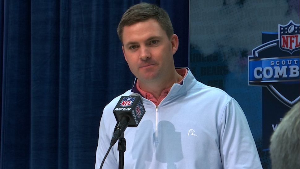 Bengals coach Zac Taylor standing in front of mic
